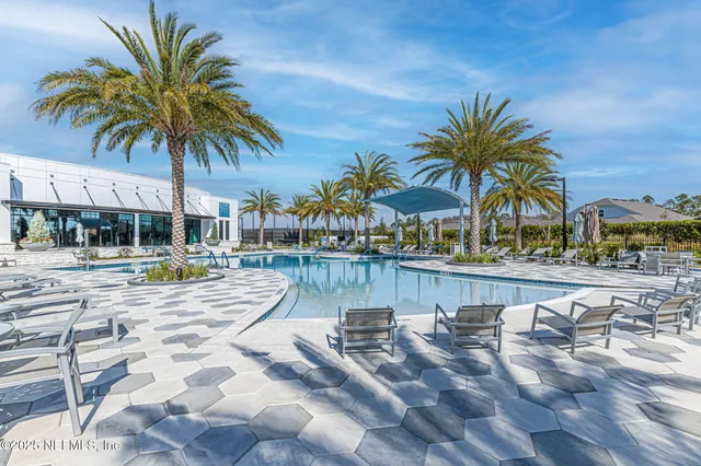 a view of swimming pool with outdoor seating and yard