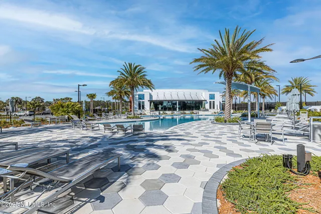 a view of a swimming pool with outdoor seating and plants