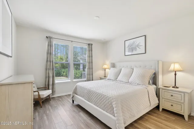 a bedroom with a bed and a lamp