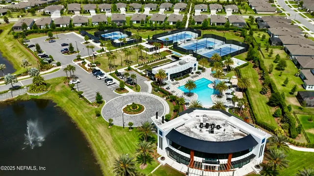 an aerial view of a swimming pool with outdoor seating