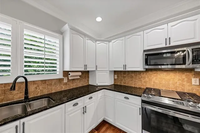 a view of an empty room with a fireplace and a floor to ceiling window