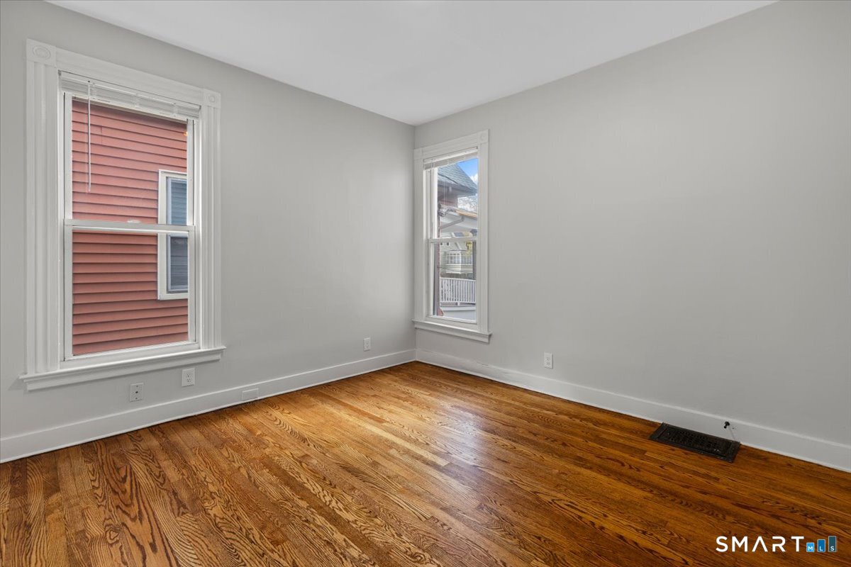 36 Maple Street, Unit 2 New Haven, CT 06511 - Photo 15 of 20 a view of an empty room with wooden floor and a window