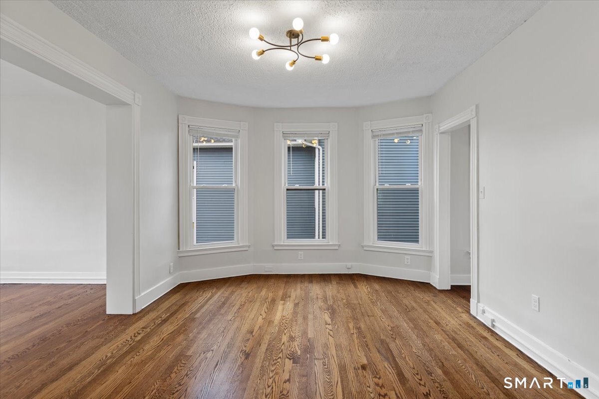 36 Maple Street, Unit 2 New Haven, CT 06511 - Photo 6 of 20 an empty room with wooden floor and windows
