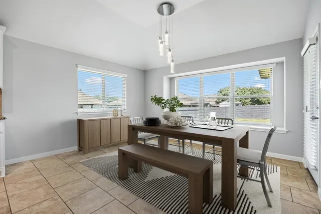 a kitchen with a table chairs and microwave