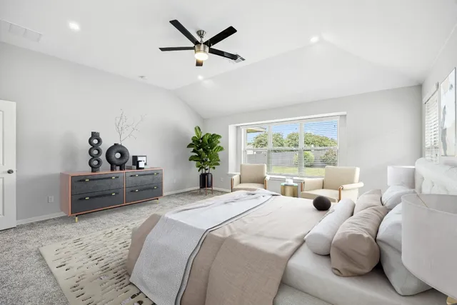 a bedroom with a bed a window and a couch