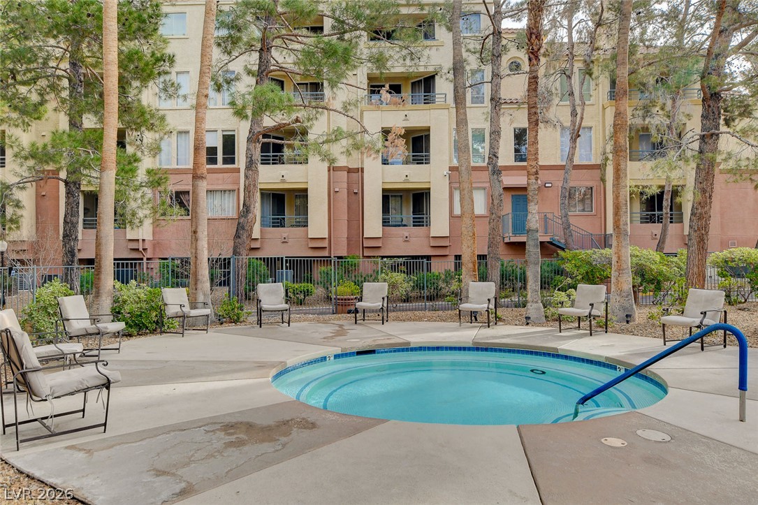 230 East Flamingo Road, Unit 333 Las Vegas, NV 89169 - Photo 42 of 61 A circular spa surrounded by mature trees offers a relaxing outdoor escape.