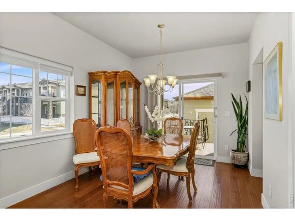 a kitchen with stainless steel appliances kitchen island granite countertop a sink refrigerator and cabinets