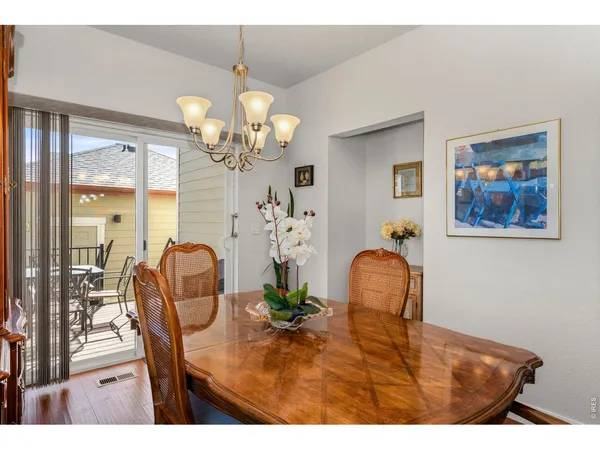 a view of a dining room with furniture and chandelier