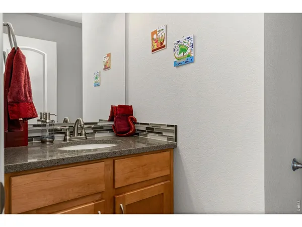 a bathroom with a sink mirror and vanity
