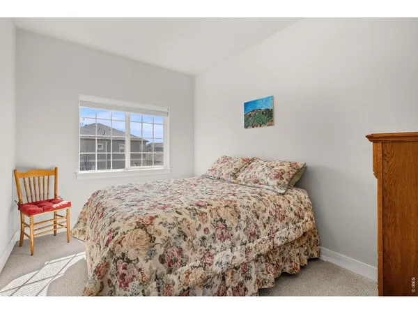 a bedroom with a bed and chair
