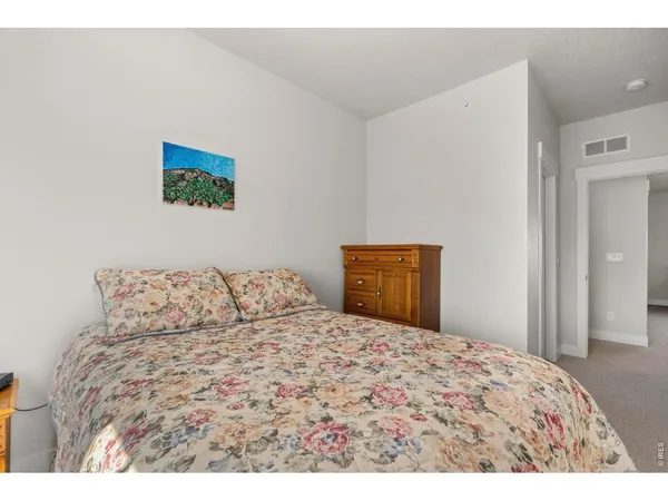 a bed room with a bed and a painting