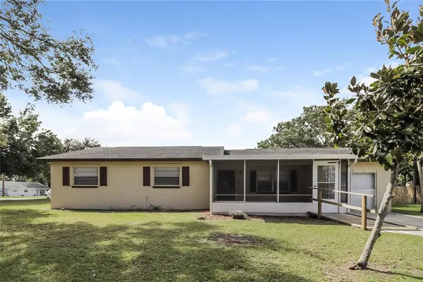 a view of a house with a yard and sitting area