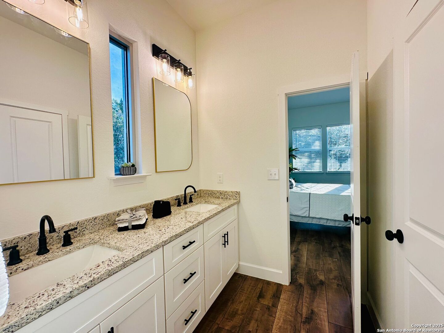 1064 Overbrook Lane Spring Branch, TX 78070 - Photo 19 of 34 a bathroom with a double vanity sink and mirror