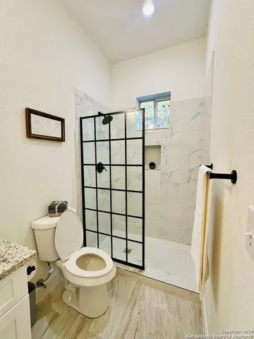 a white toilet sitting next to a bathroom sink