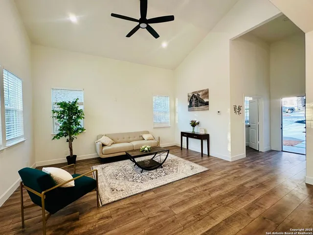 a living room with furniture and a wooden floor