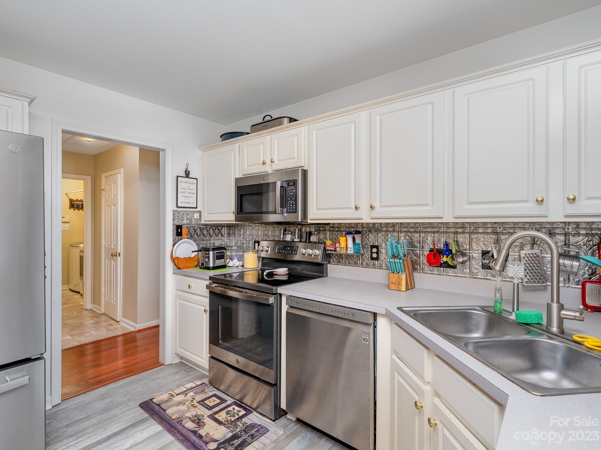 12119 Shadow Ridge Lane Charlotte, NC 28273 - Photo 11 of 28 a kitchen with stainless steel appliances granite countertop a sink dishwasher a stove and a refrigerator with cabinets