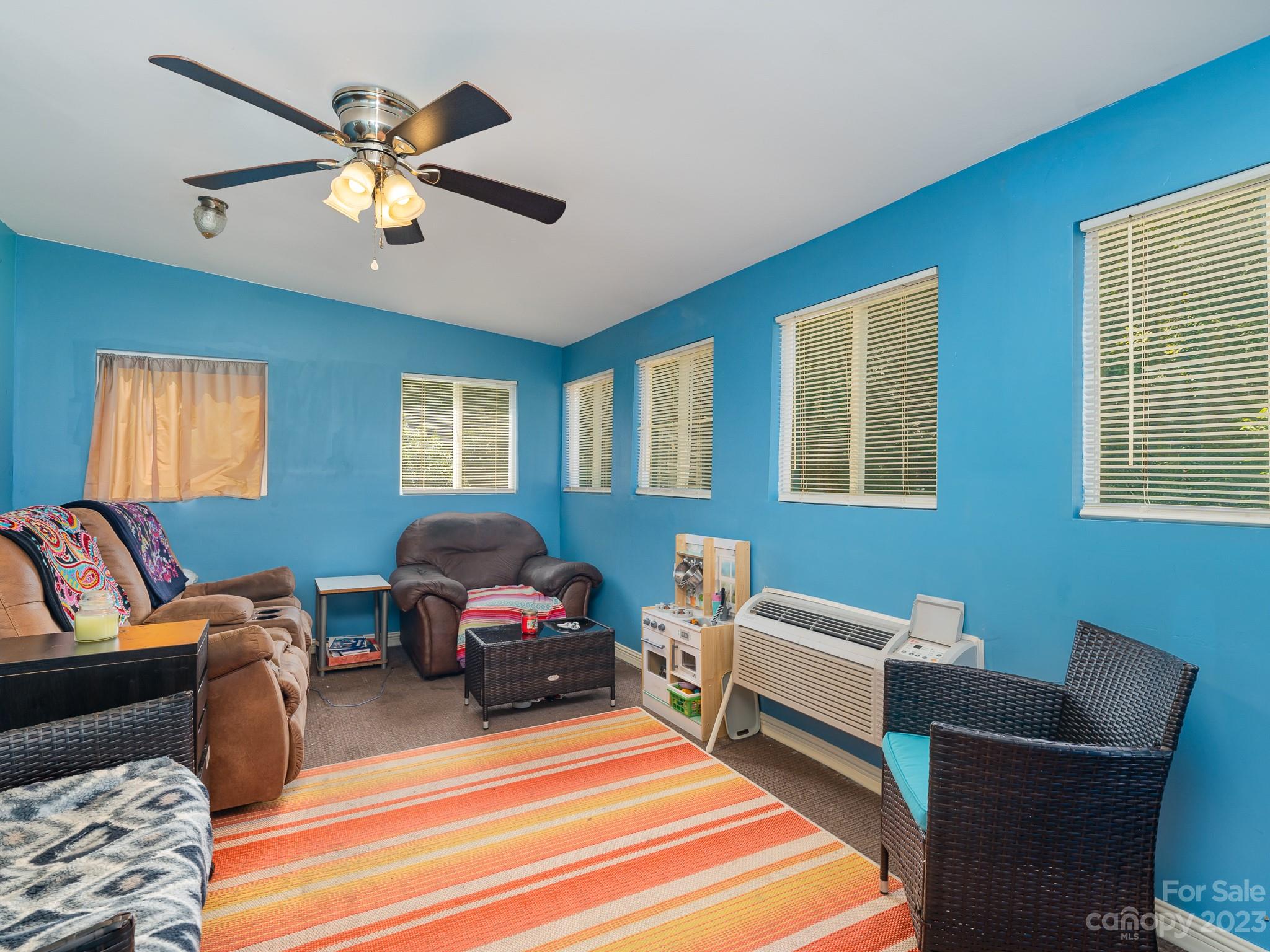 12119 Shadow Ridge Lane Charlotte, NC 28273 - Photo 12 of 28 a living room with furniture a ceiling fan and a window