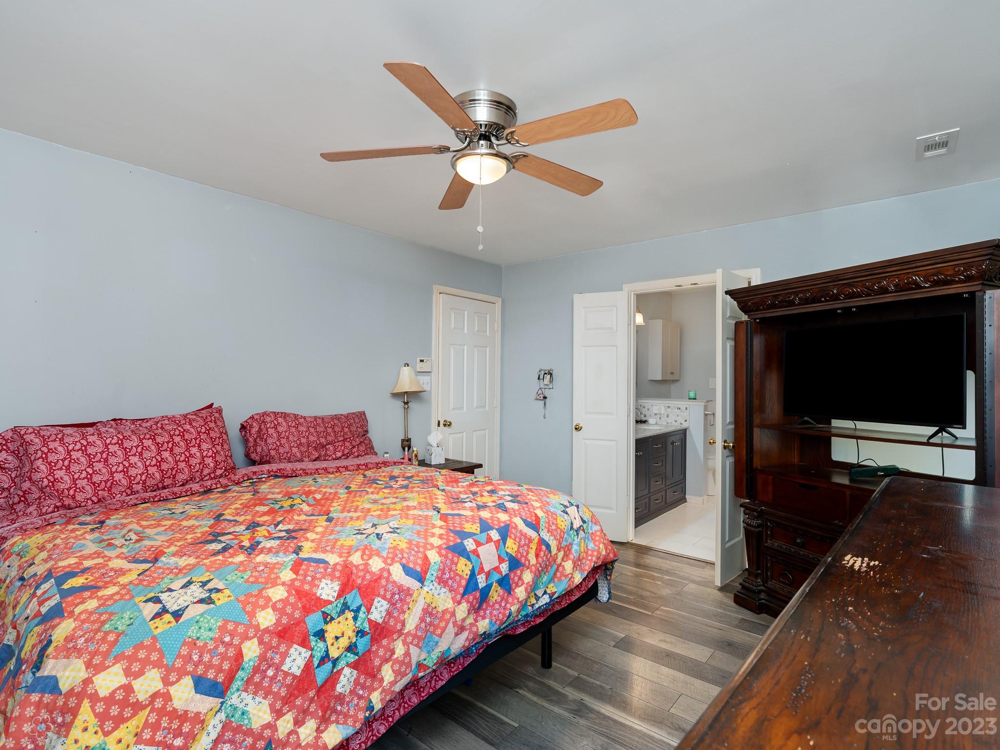 12119 Shadow Ridge Lane Charlotte, NC 28273 - Photo 15 of 28 a bedroom with a bed and a ceiling fan