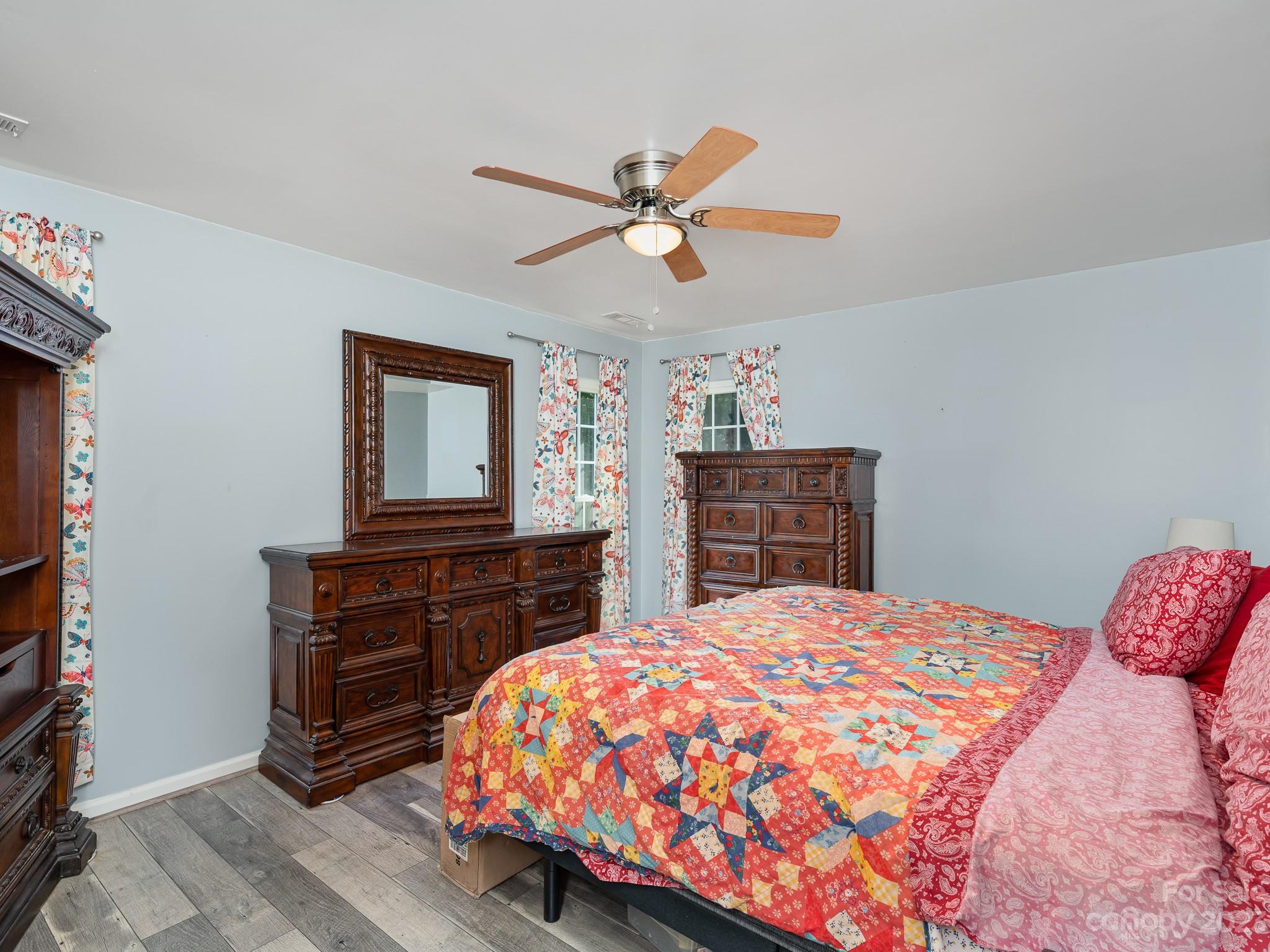 12119 Shadow Ridge Lane Charlotte, NC 28273 - Photo 16 of 28 a bedroom with a bed and a dresser