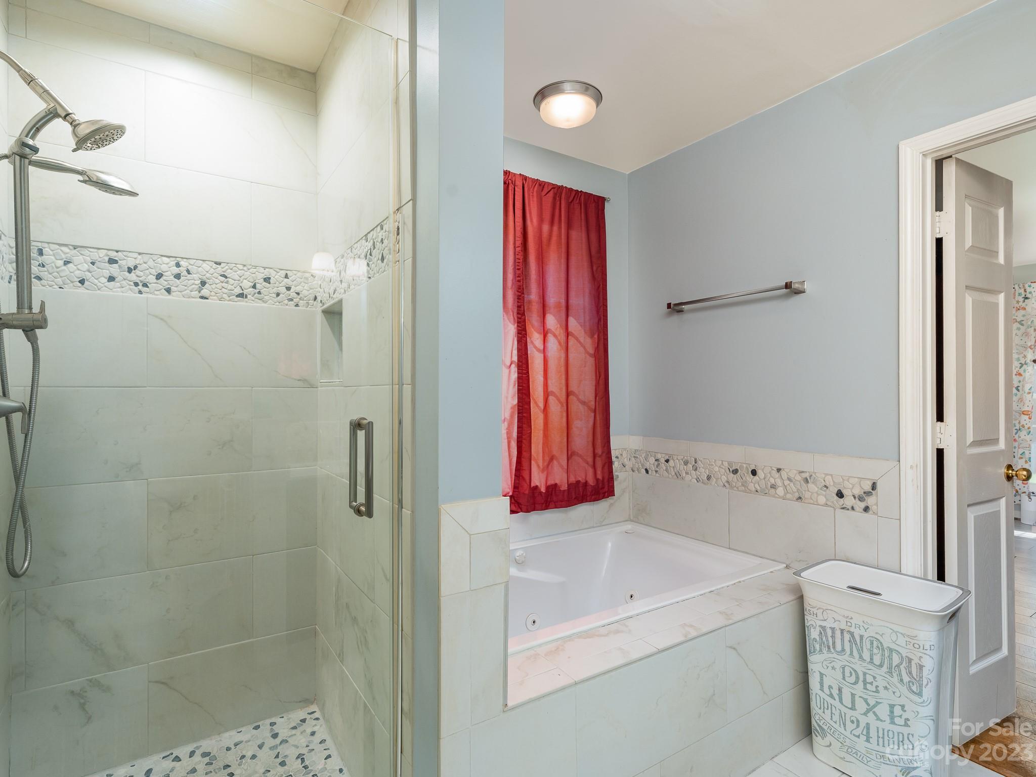 12119 Shadow Ridge Lane Charlotte, NC 28273 - Photo 18 of 28 a bathroom with a bathtub and a shower