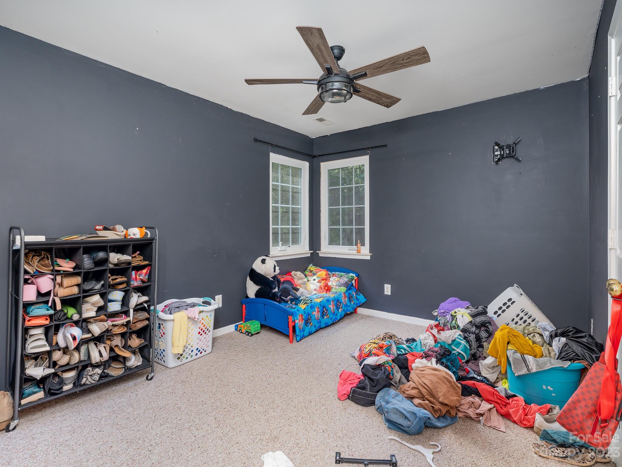 12119 Shadow Ridge Lane Charlotte, NC 28273 - Photo 20 of 28 a bedroom with a bed and a chandelier
