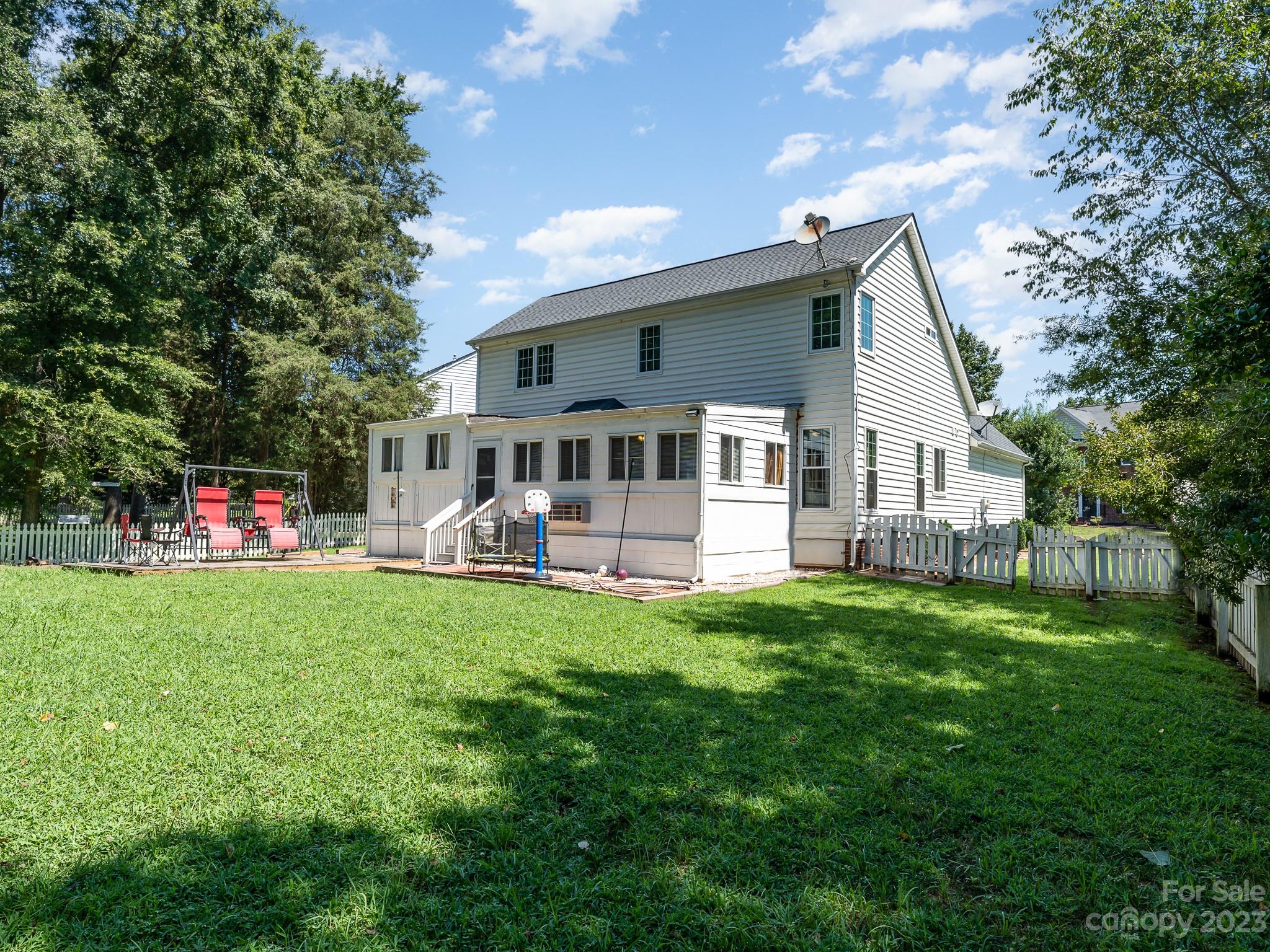 12119 Shadow Ridge Lane Charlotte, NC 28273 - Photo 27 of 28 a view of a house with a backyard and a patio
