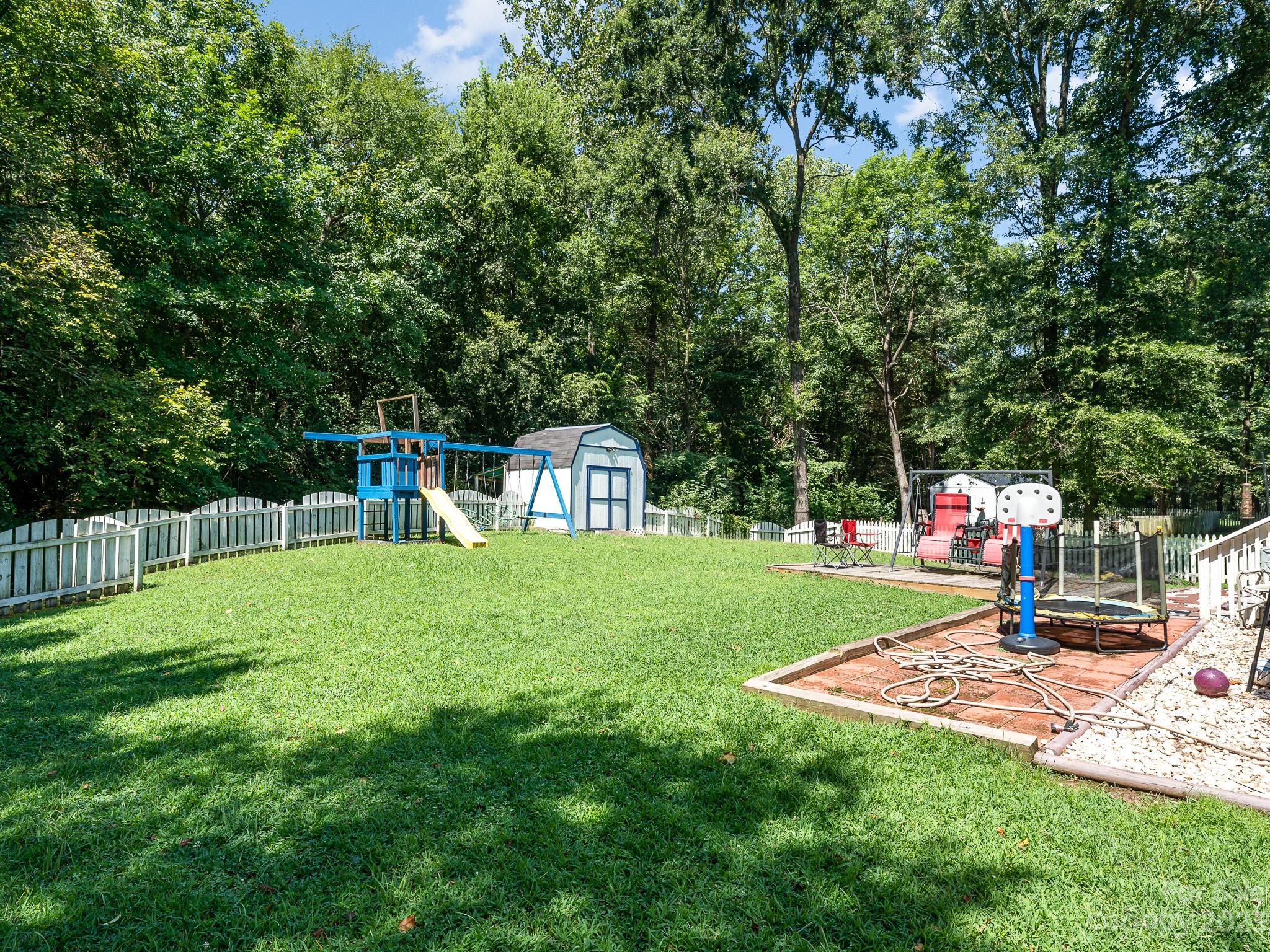 12119 Shadow Ridge Lane Charlotte, NC 28273 - Photo 28 of 28 a childrens park with lots of swings and slides
