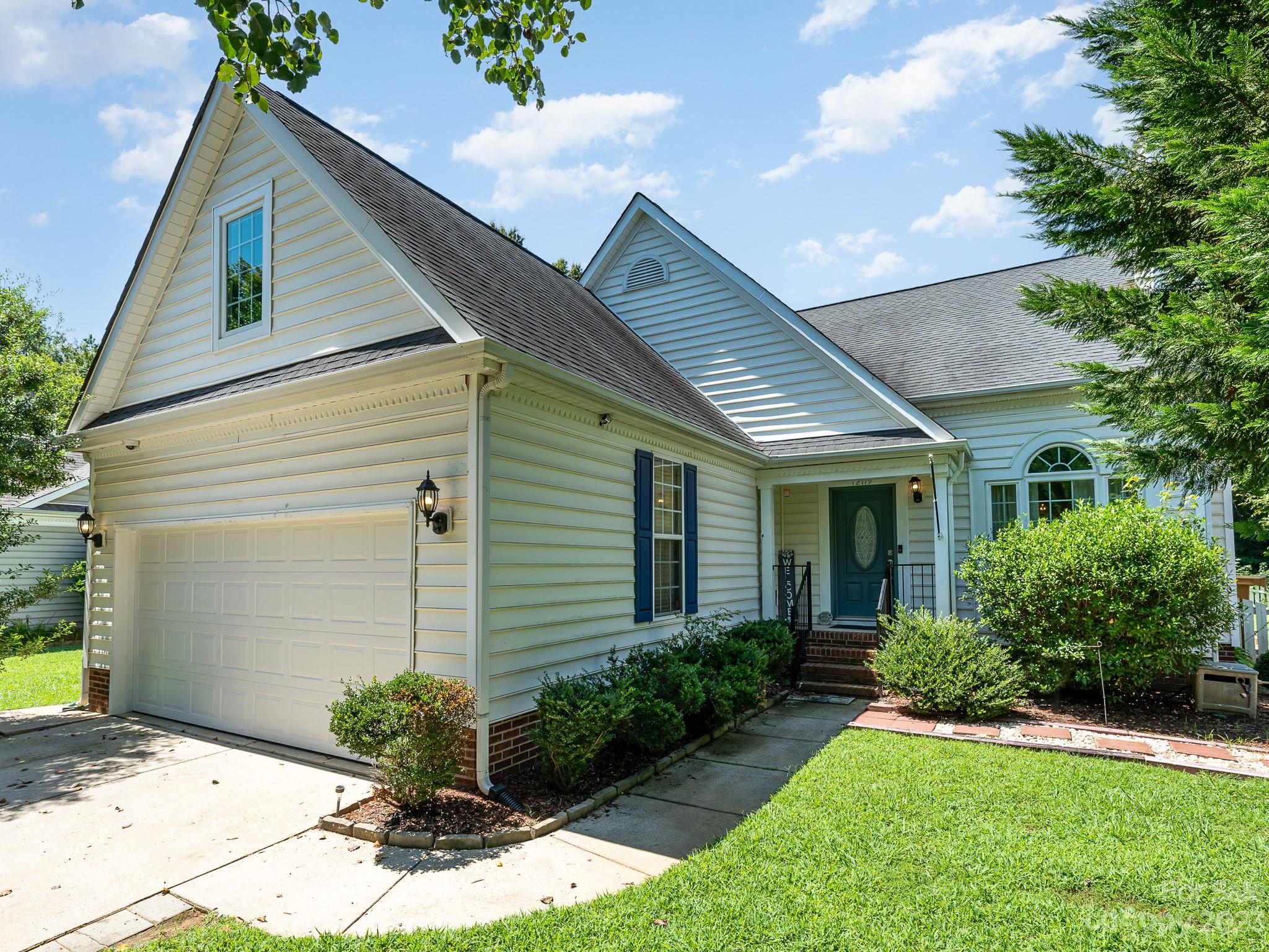 12119 Shadow Ridge Lane Charlotte, NC 28273 - Photo 4 of 28 a front view of a house with a yard and potted plants