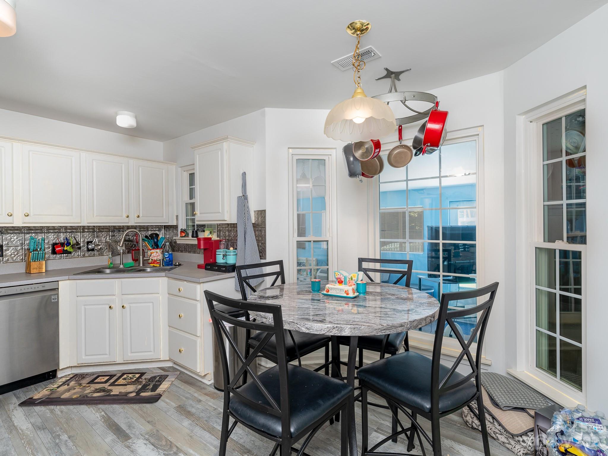 12119 Shadow Ridge Lane Charlotte, NC 28273 - Photo 10 of 28 a kitchen with a dining table and chairs in it