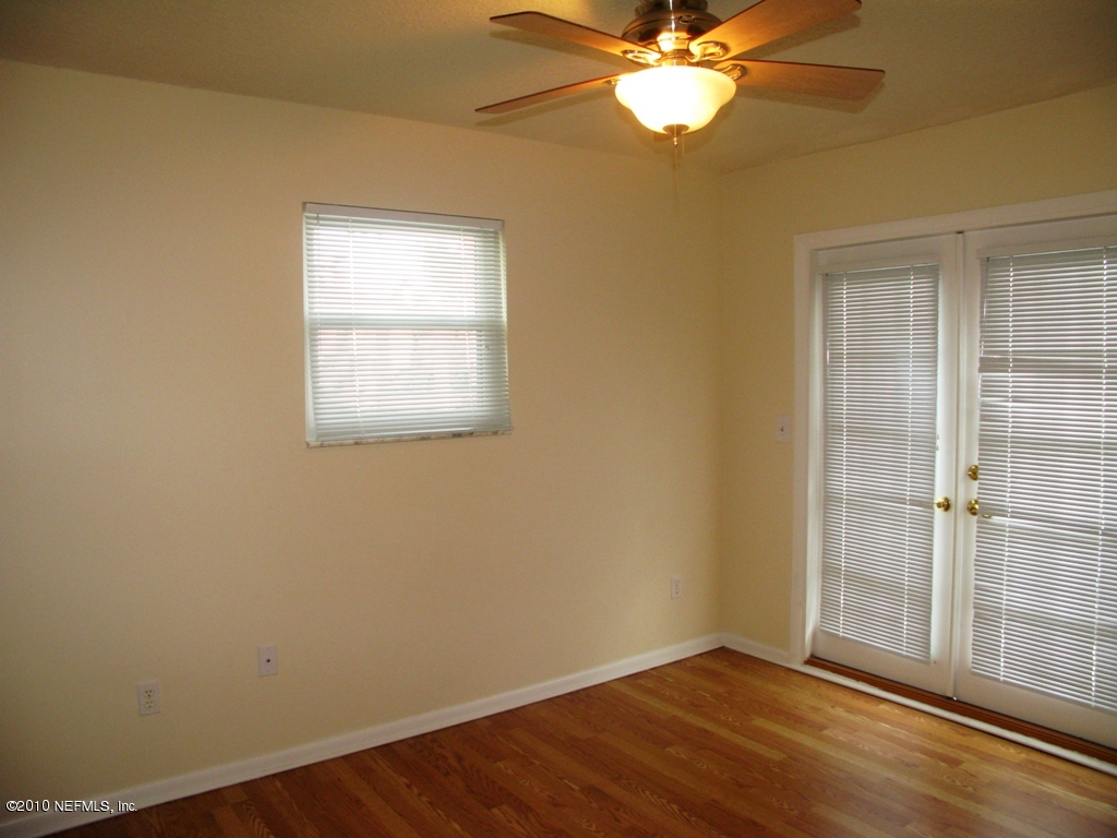 317 Magnolia Street Neptune Beach, FL 32266 - Photo 11 of 13 an empty room with a window and wooden floor