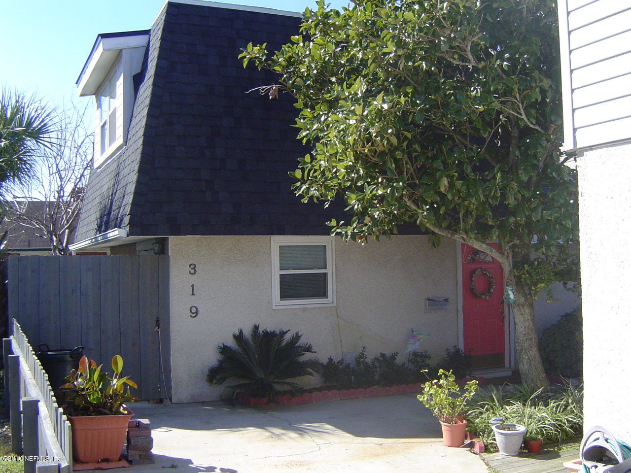 317 Magnolia Street Neptune Beach, FL 32266 - Photo 2 of 13 a potted plant sitting in front of a house