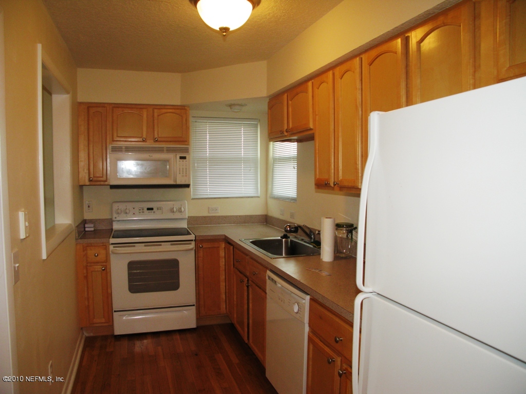 317 Magnolia Street Neptune Beach, FL 32266 - Photo 6 of 13 a kitchen with a sink a stove and cabinets
