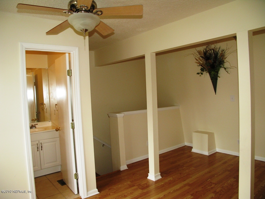 317 Magnolia Street Neptune Beach, FL 32266 - Photo 10 of 13 a view of a hallway with wooden floor and a bathroom