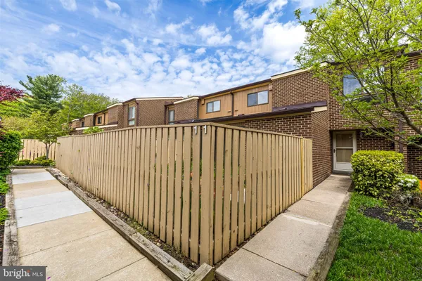 a view of a wooden fence and a pathway