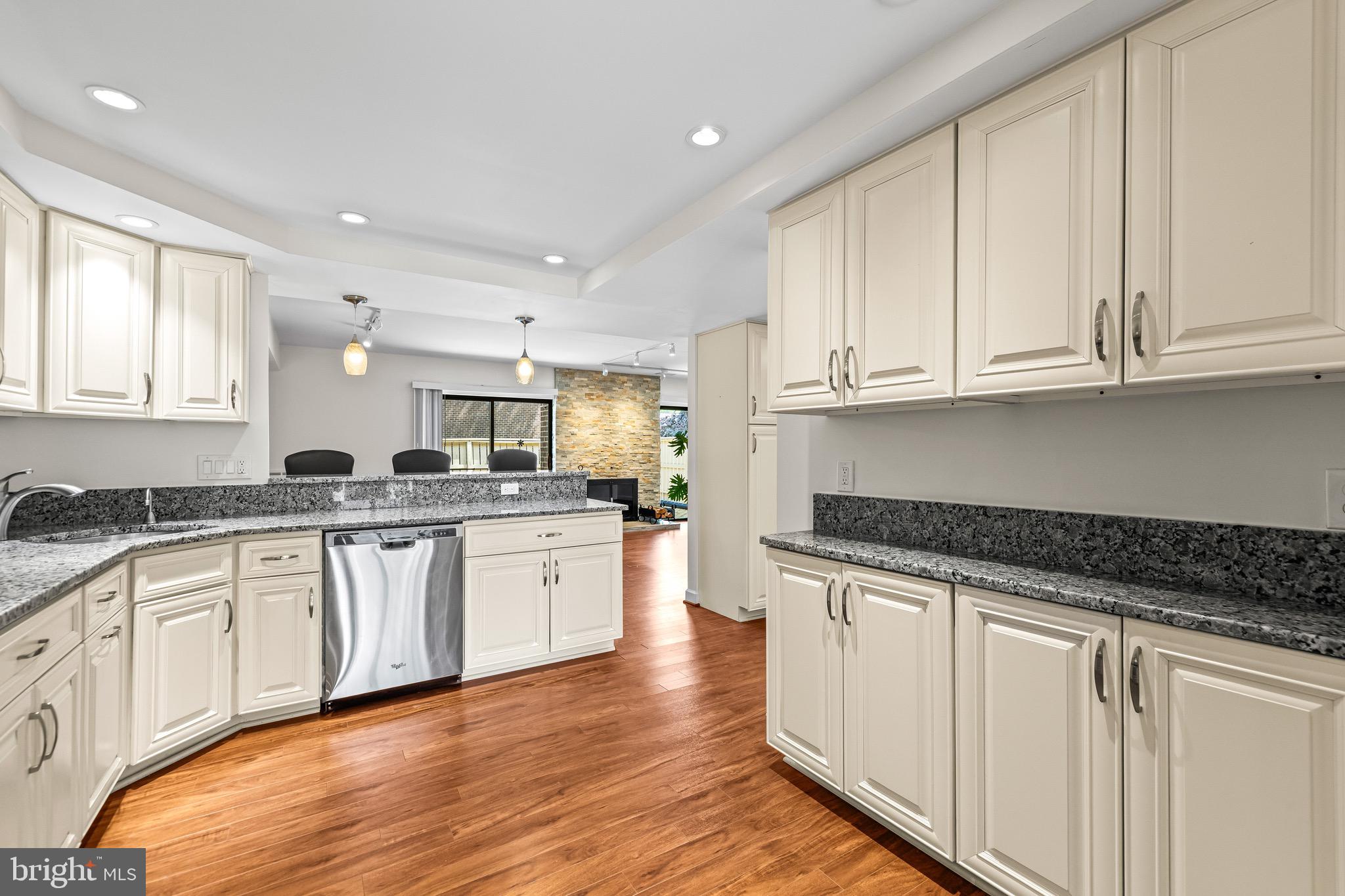 11 Tanner Court, Unit G Baltimore, MD 21208 - Photo 14 of 38 a kitchen with granite countertop white cabinets and white appliances