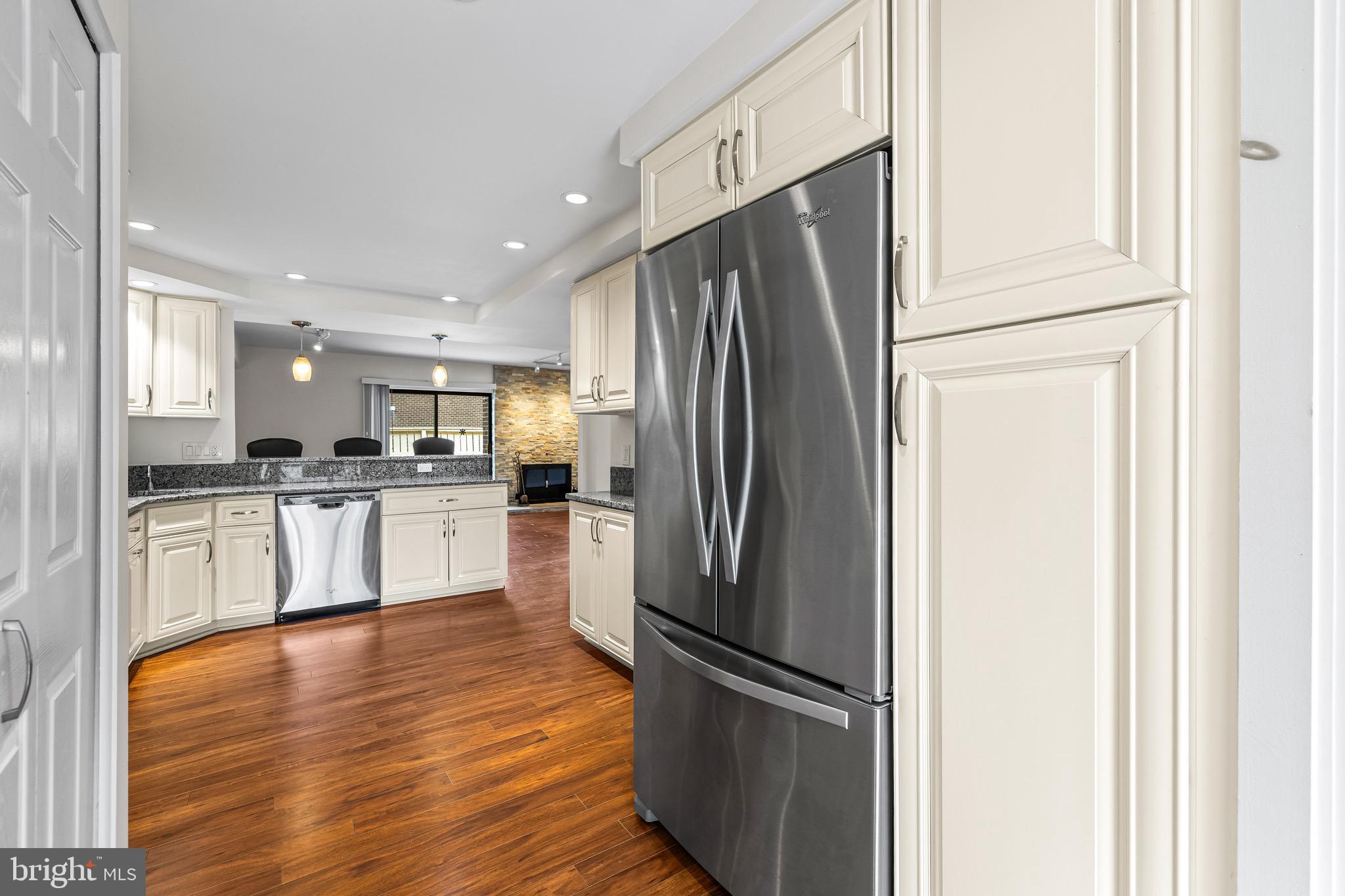 11 Tanner Court, Unit G Baltimore, MD 21208 - Photo 15 of 38 a kitchen with white cabinets and stainless steel appliances