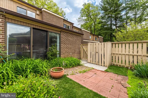 a view of a backyard with potted plants and floor to ceiling window