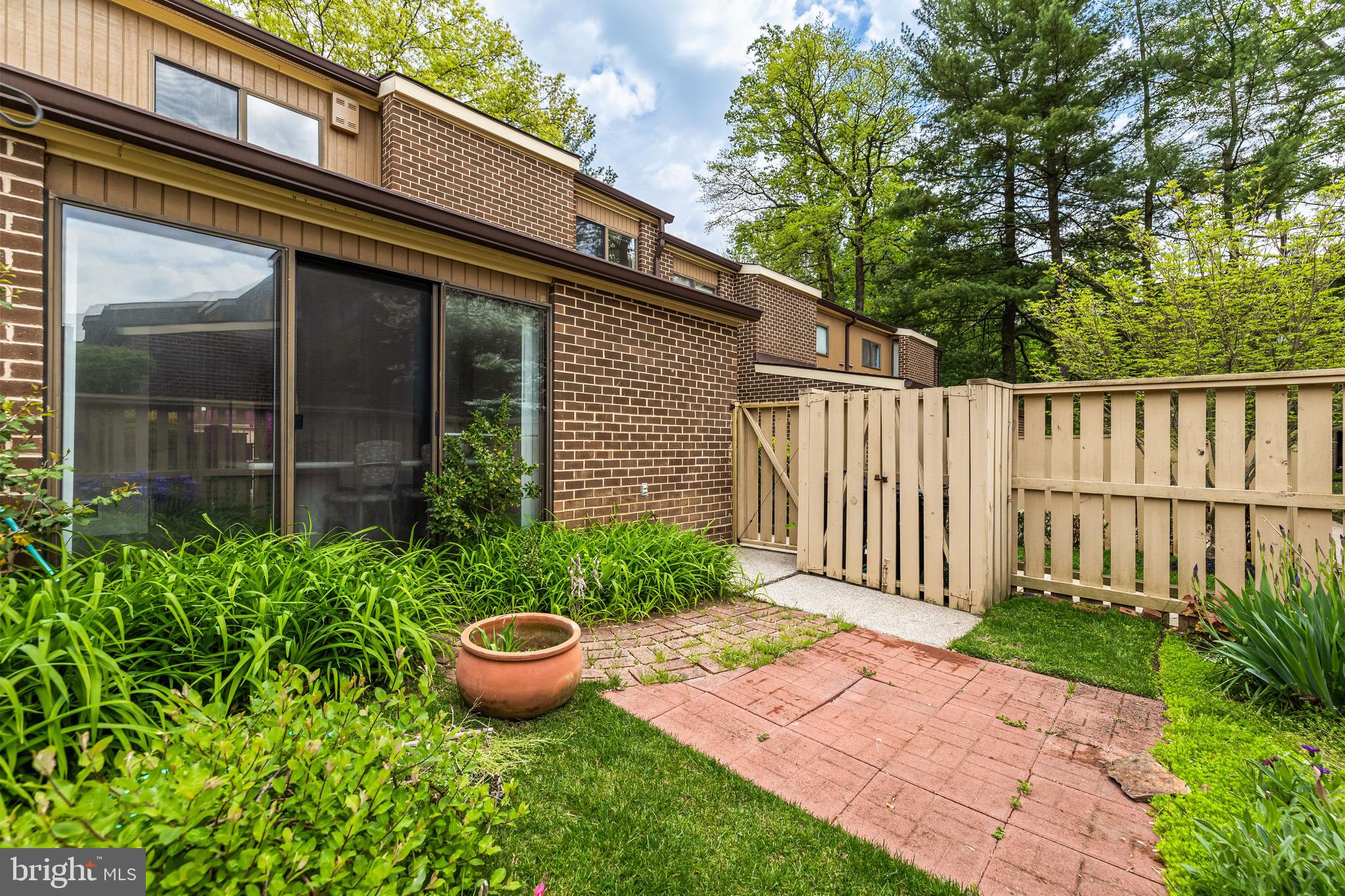 11 Tanner Court, Unit G Baltimore, MD 21208 - Photo 18 of 38 a view of a backyard with potted plants and floor to ceiling window