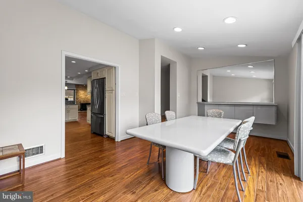 a view of a dining room with furniture and wooden floor