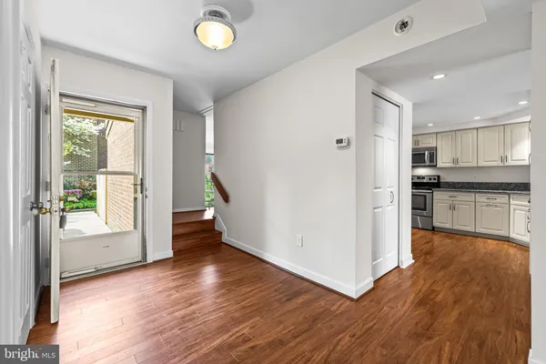 a view of kitchen with wooden floor and electronic appliances