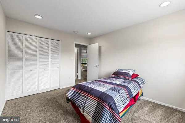 a bedroom with a bed and a painting