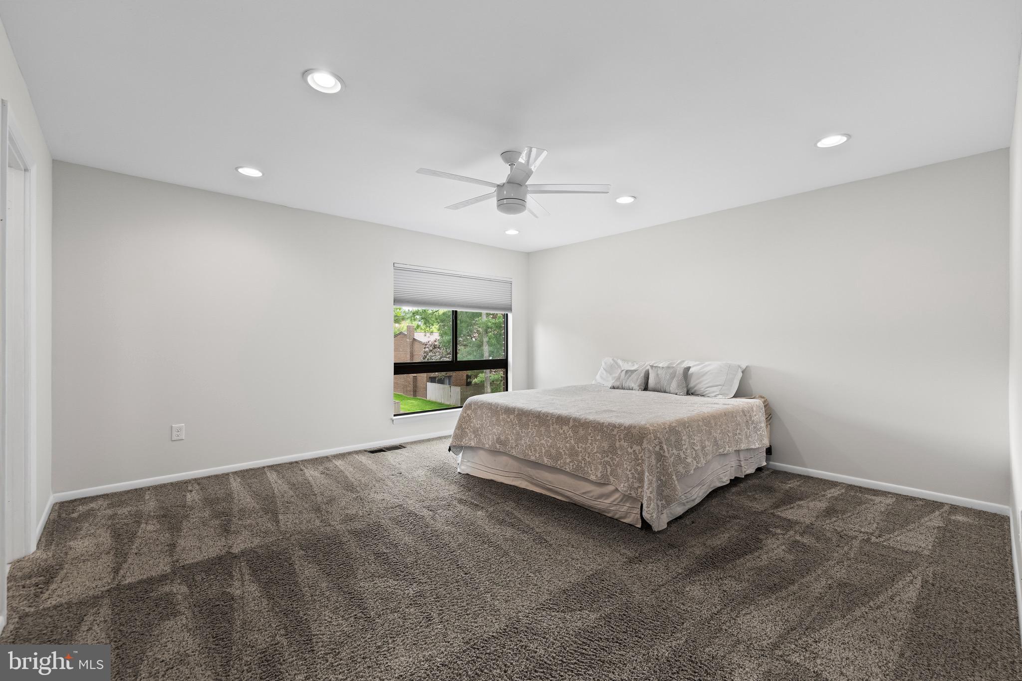 11 Tanner Court, Unit G Baltimore, MD 21208 - Photo 28 of 38 a spacious bedroom with a bed and a window