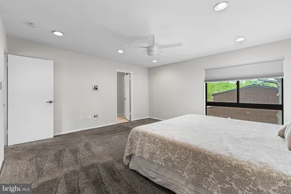 a bedroom with a large bed and a large window