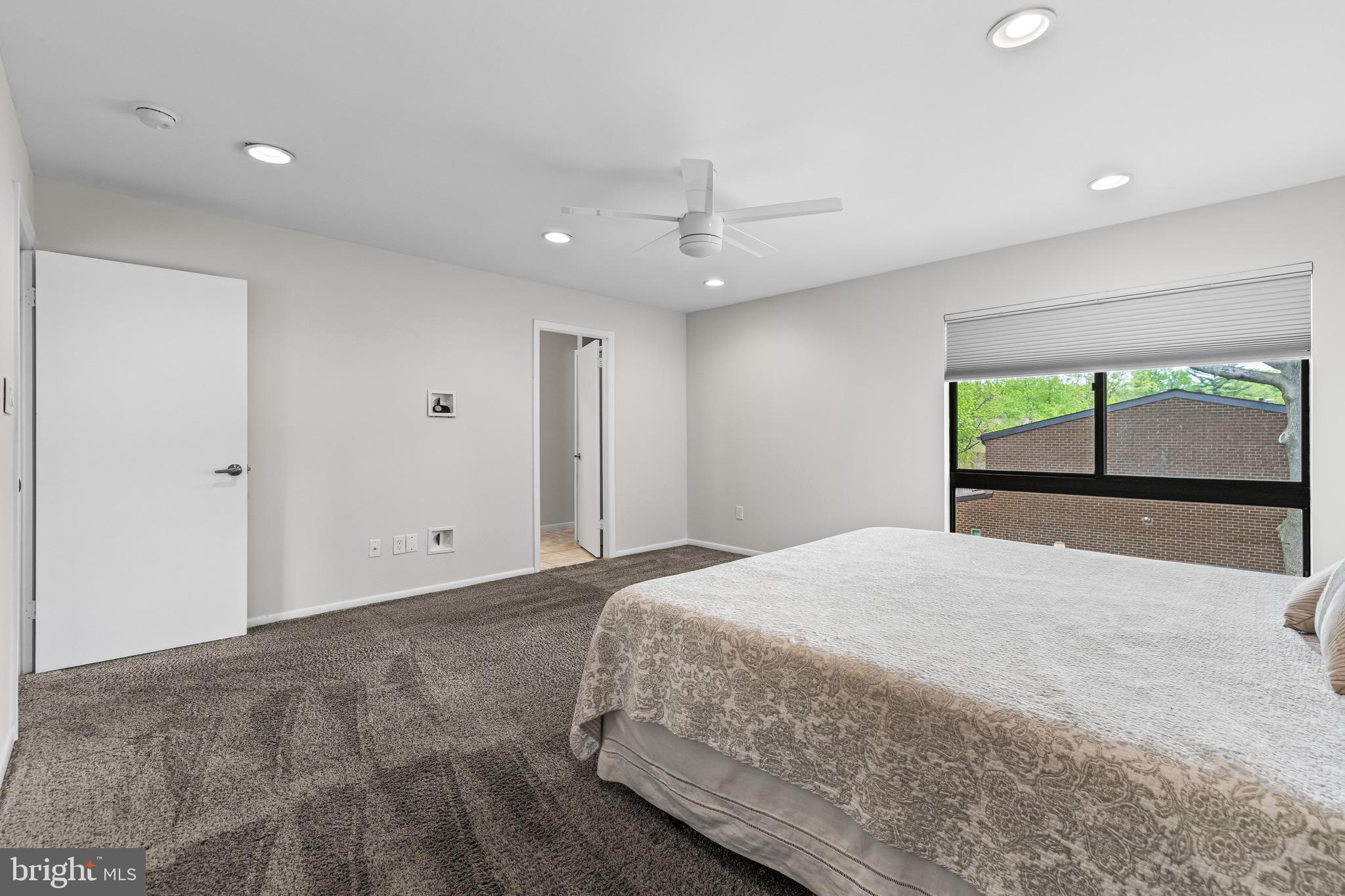 11 Tanner Court, Unit G Baltimore, MD 21208 - Photo 29 of 38 a bedroom with a large bed and a large window