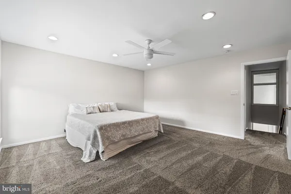 a room with a bed and a ceiling fan