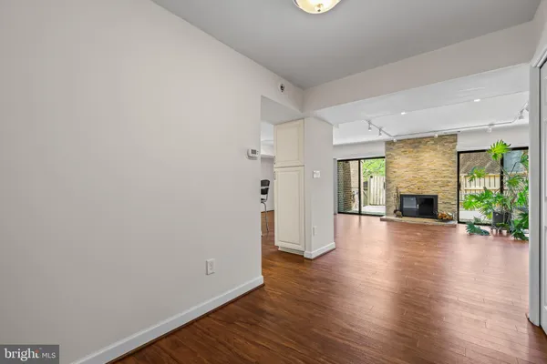 a view of a room with wooden floor and fireplace
