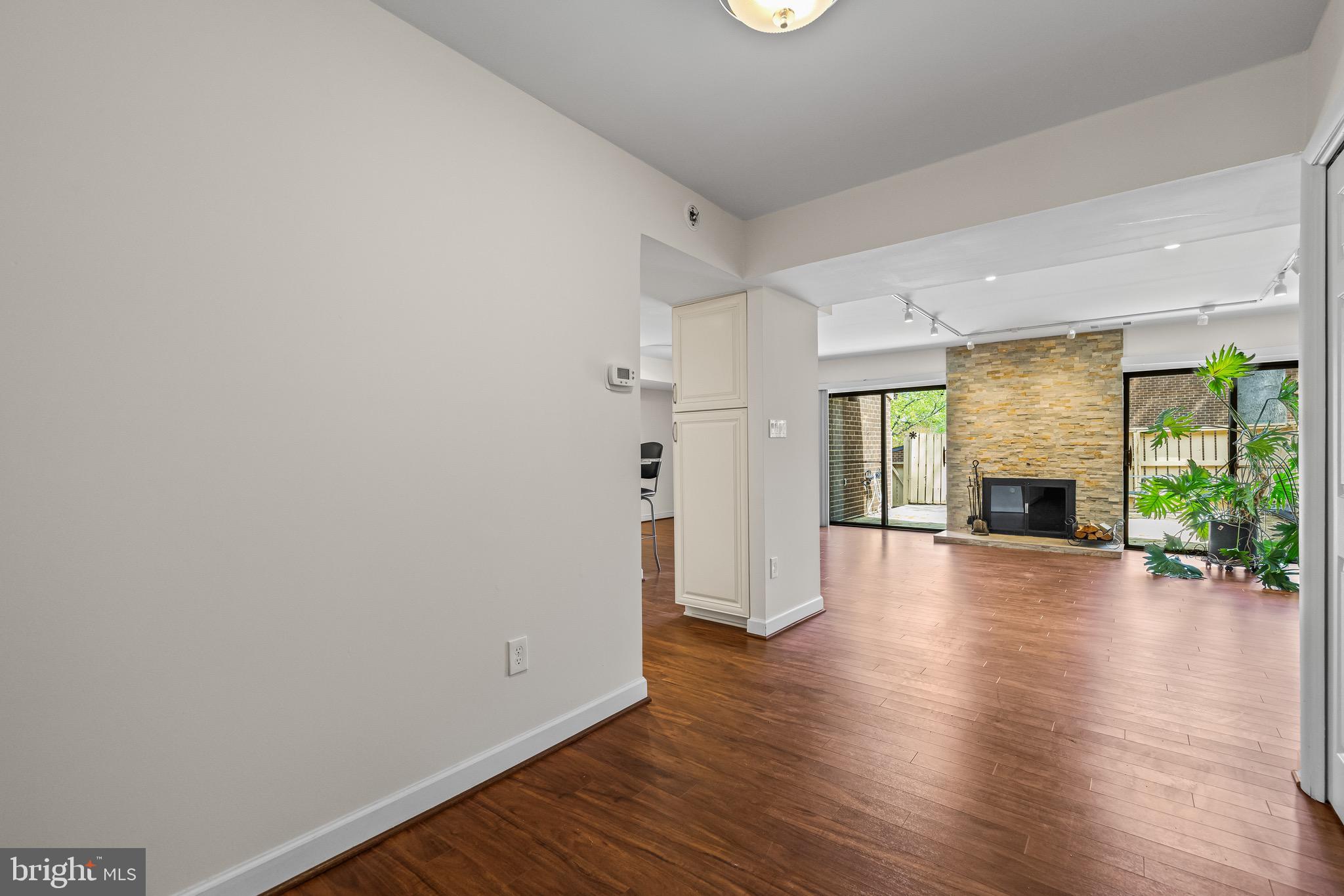 11 Tanner Court, Unit G Baltimore, MD 21208 - Photo 3 of 38 a view of a room with wooden floor and fireplace