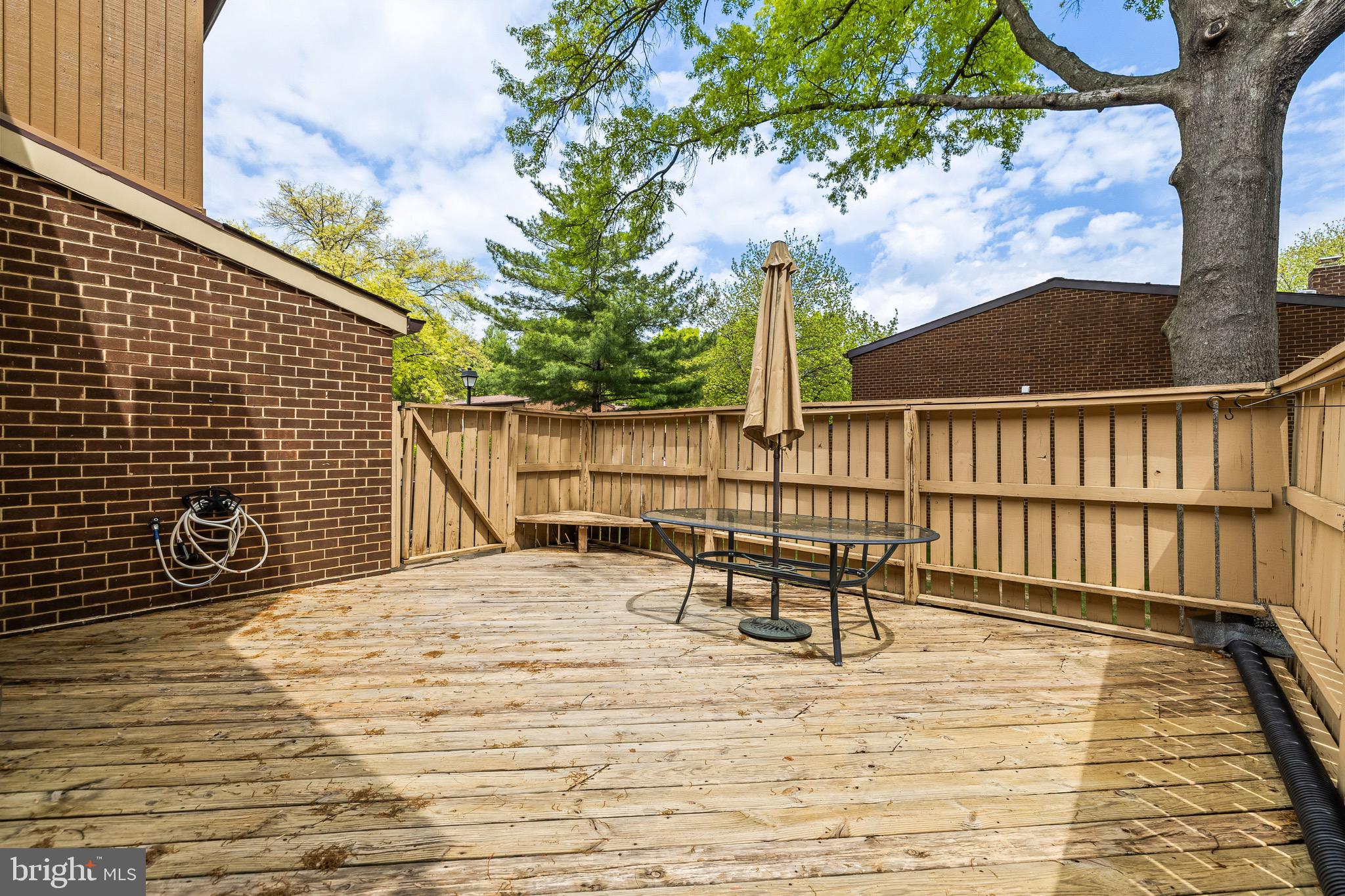 11 Tanner Court, Unit G Baltimore, MD 21208 - Photo 35 of 38 a roof deck with table and chairs and wooden floor