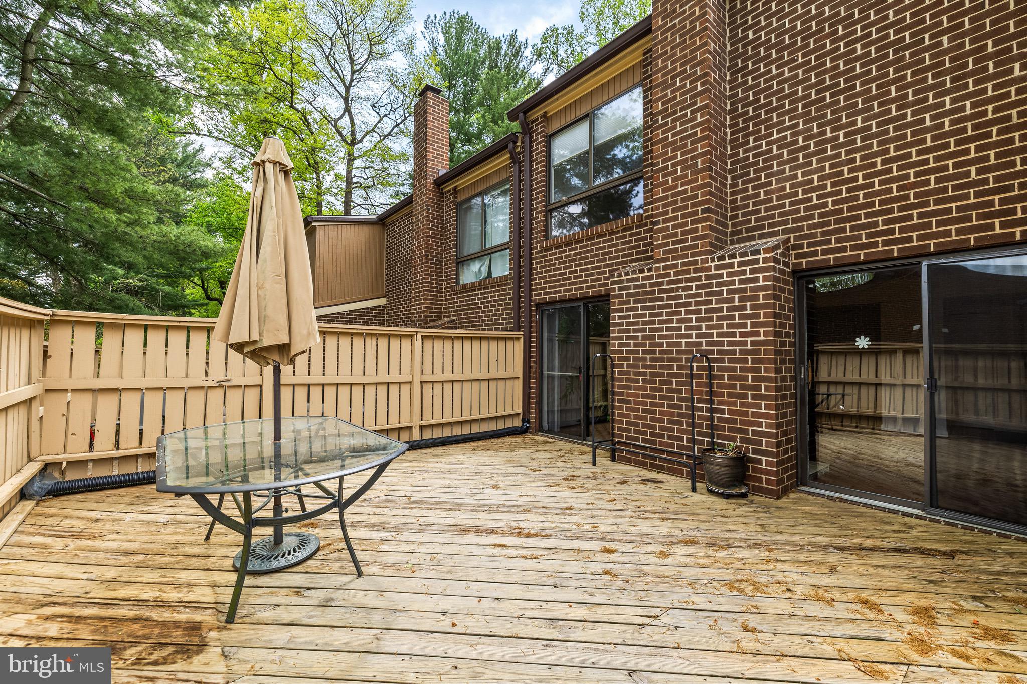 11 Tanner Court, Unit G Baltimore, MD 21208 - Photo 36 of 38 a view of a brick house with backyard and wooden fence
