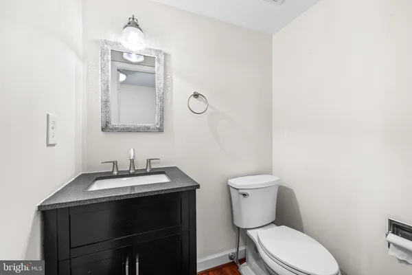 a bathroom with a toilet a sink and mirror